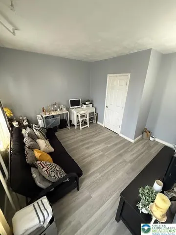 a living room with a bed furniture and a window