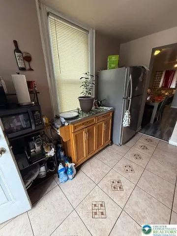 a kitchen with a stove a refrigerator and a sink