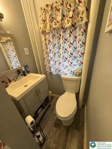 a bedroom with a bed and large windows