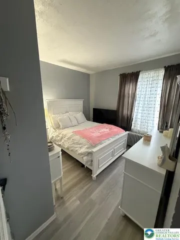 a bed sitting in a bedroom next to a window