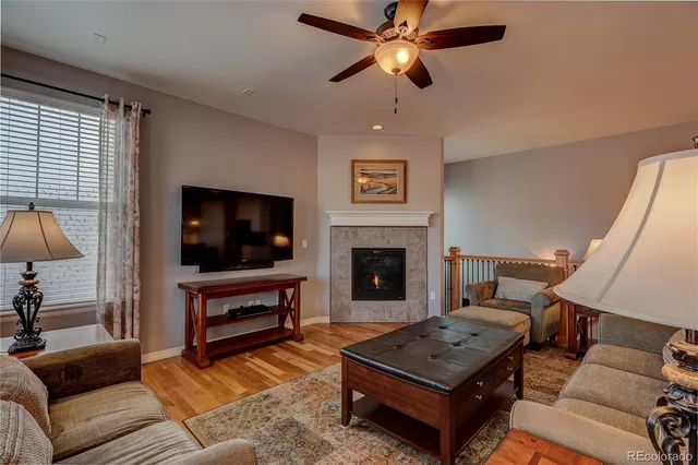 a living room with furniture a flat screen tv and a fireplace