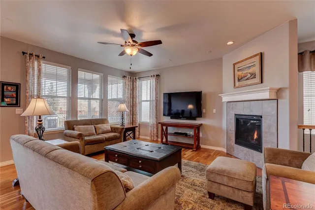 a living room with furniture a fireplace and a flat screen tv