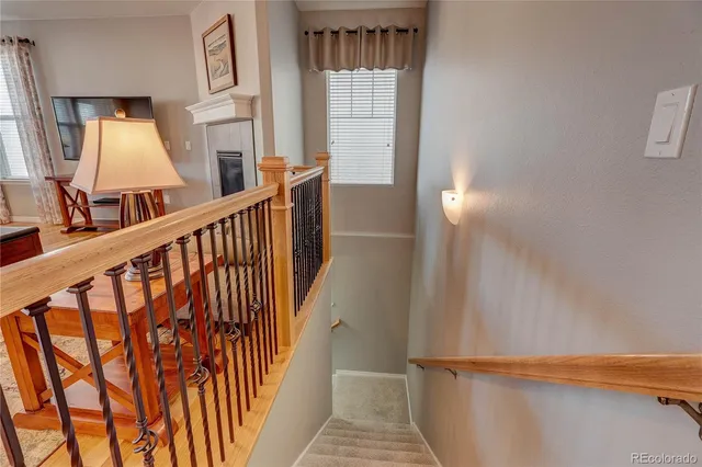 a view of staircase with white walls and a window