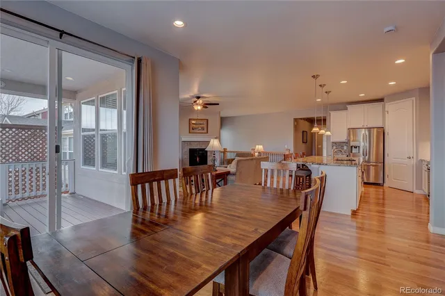 a dining room with furniture and wooden floor