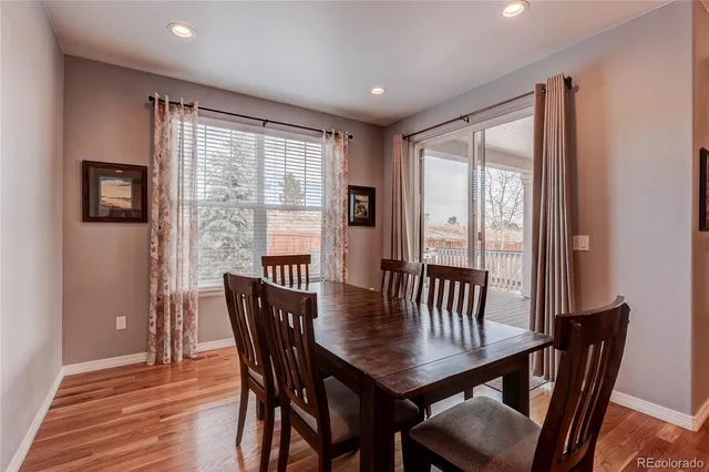 a view of a dining room with furniture window and wooden floor