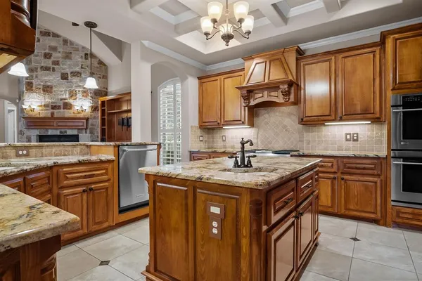 a kitchen with stainless steel appliances granite countertop a sink stove cabinets and wooden floor