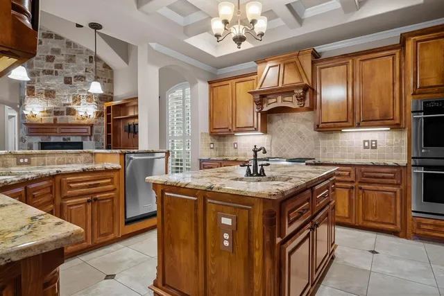 a kitchen with stainless steel appliances granite countertop a sink stove cabinets and wooden floor