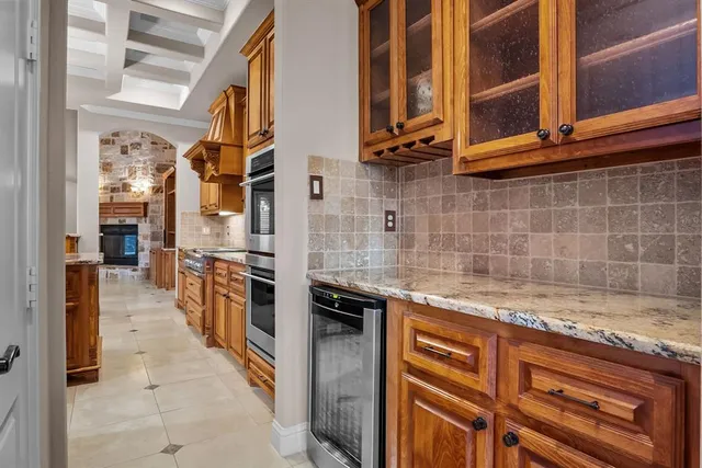 a kitchen with stainless steel appliances granite countertop a stove and cabinets