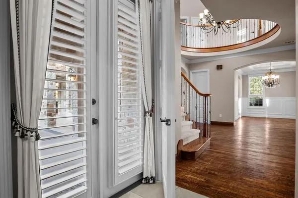 a very nice looking room with wooden floor and a chandelier