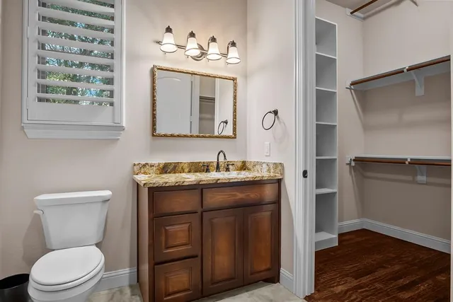 a bathroom with a toilet a sink and mirror