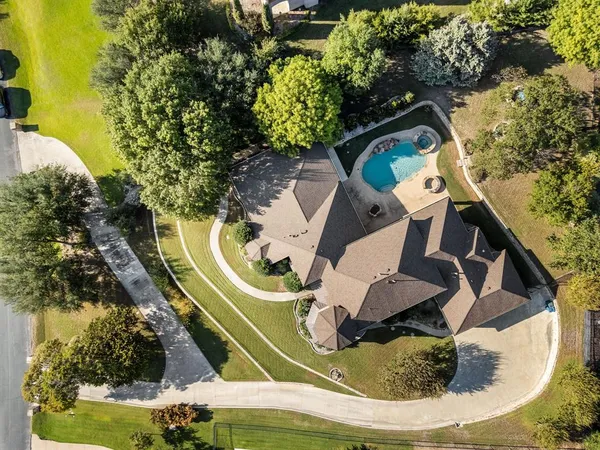 an aerial view of a house with a swimming pool
