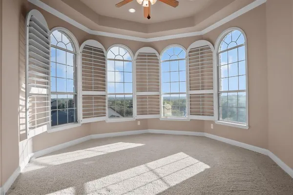 a view of livingroom with furniture and large windows
