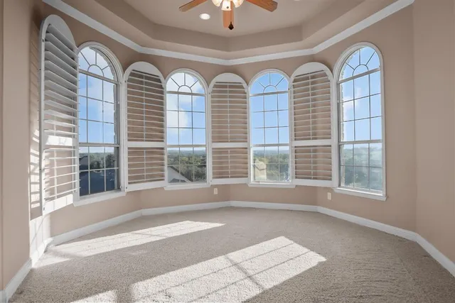 a view of livingroom with furniture and large windows