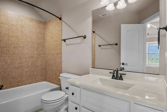 a bathroom with a sink toilet a mirror and shower