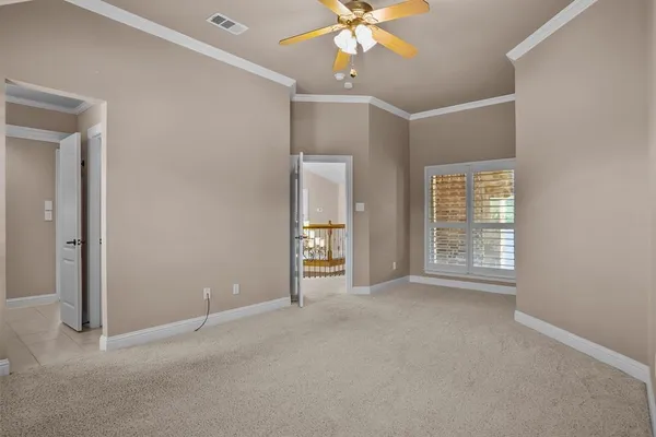 an empty room with fan and windows