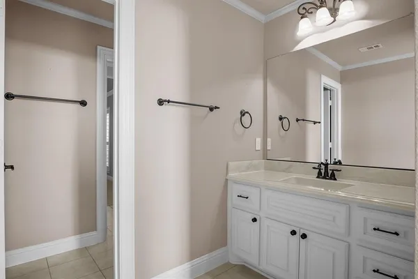 a bathroom with a granite countertop sink a mirror and shower