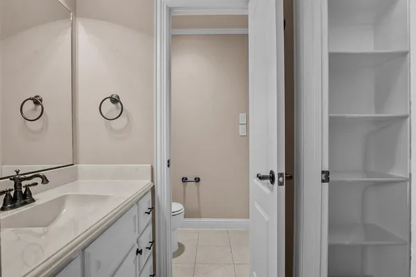 a bathroom with a granite countertop sink a mirror and shower