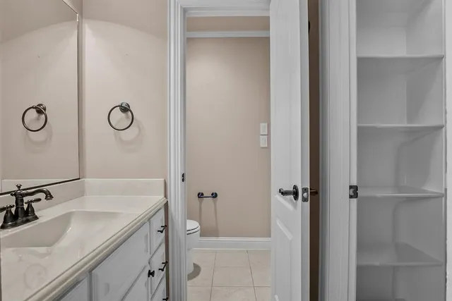 a bathroom with a granite countertop sink a mirror and shower