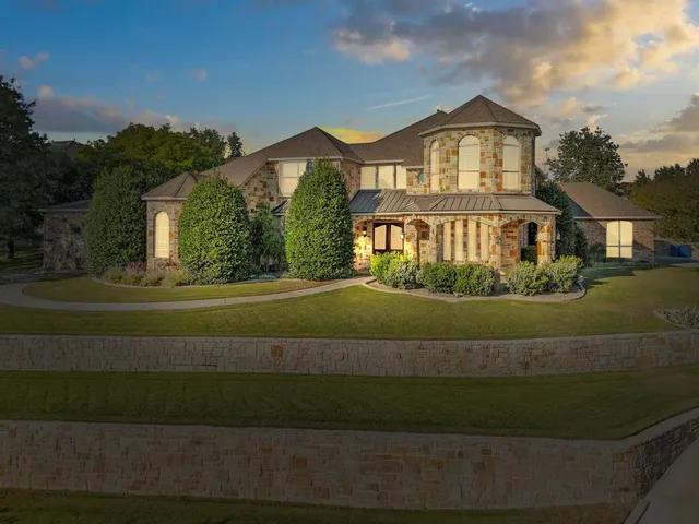a spacious bedroom with a bed and a chandelier
