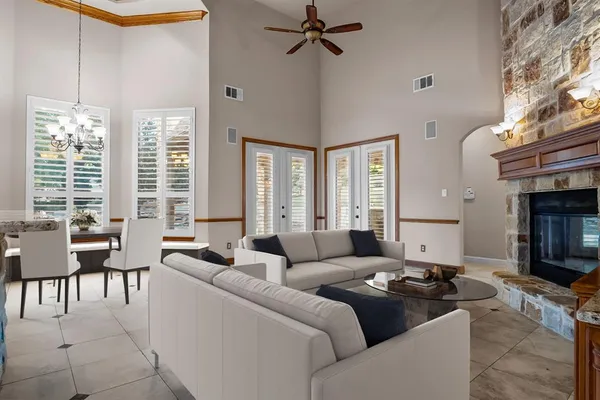 a living room with furniture a chandelier and a table
