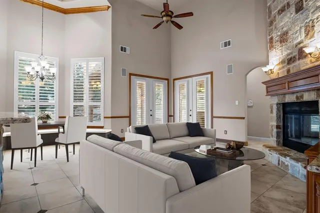 a living room with furniture a chandelier and a table