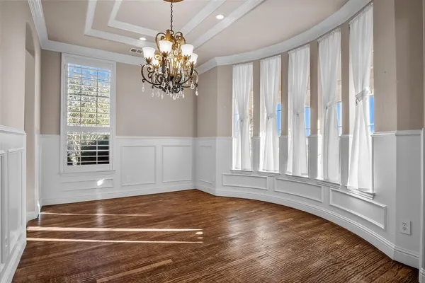 a view of wooden floor and chandelier in living room