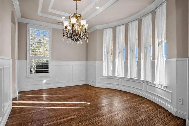 a view of wooden floor and chandelier in living room