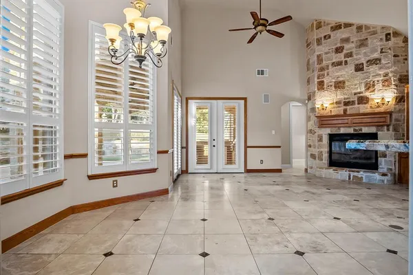 a view of an empty room with a fireplace and a window