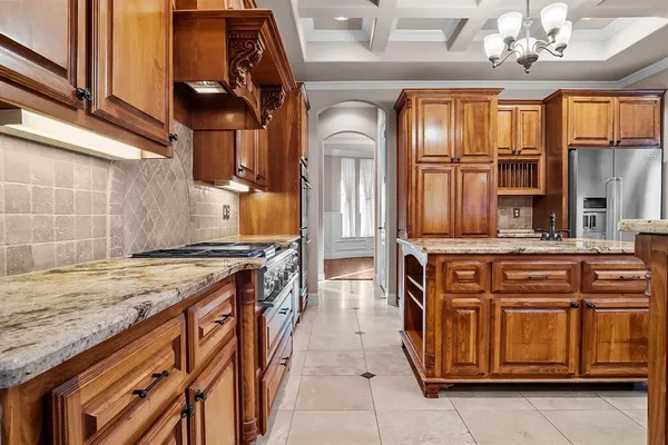 a kitchen with stainless steel appliances granite countertop a stove and a sink