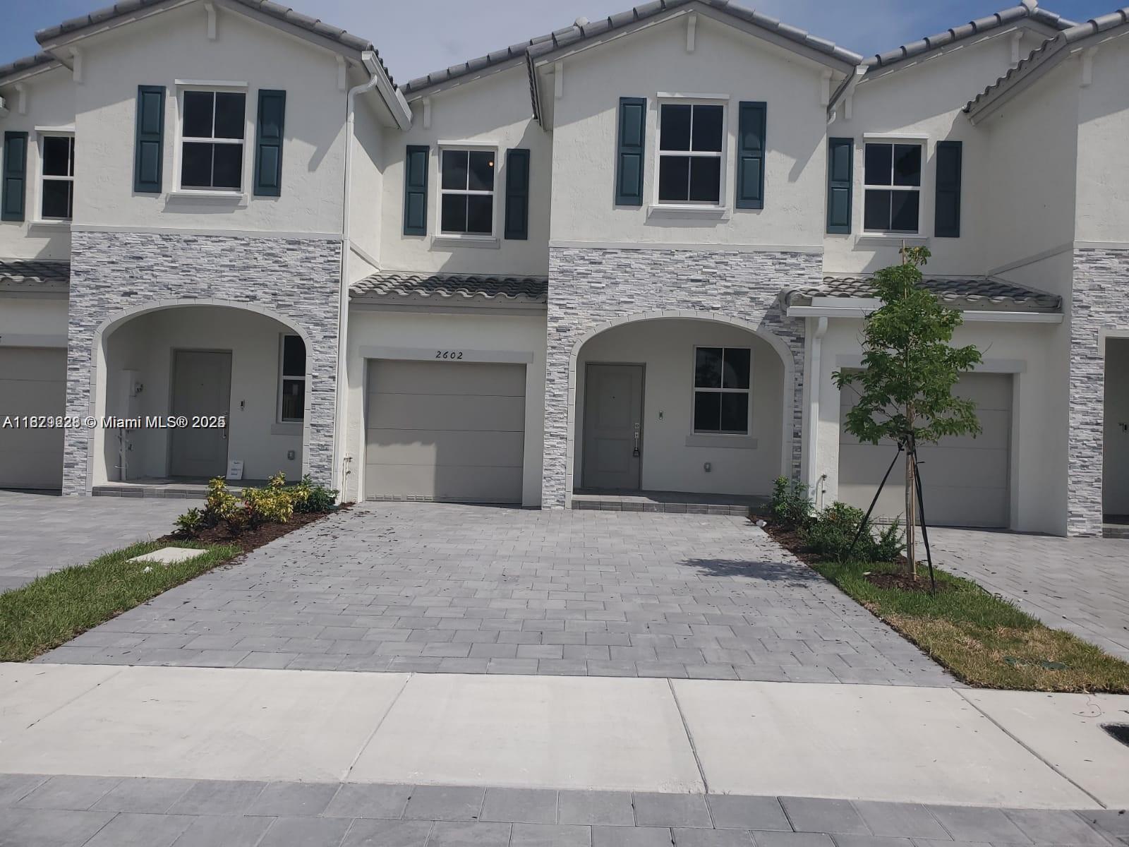 a front view of a house with yard