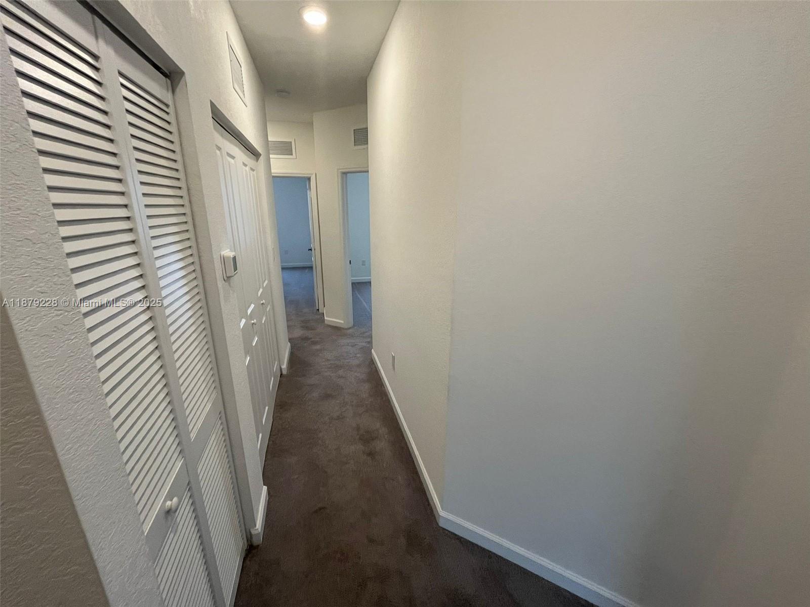 2602 Southeast 11th Street, Unit 2602 Homestead, FL 33035 - Photo 14 of 22 a view of a hallway with a white door