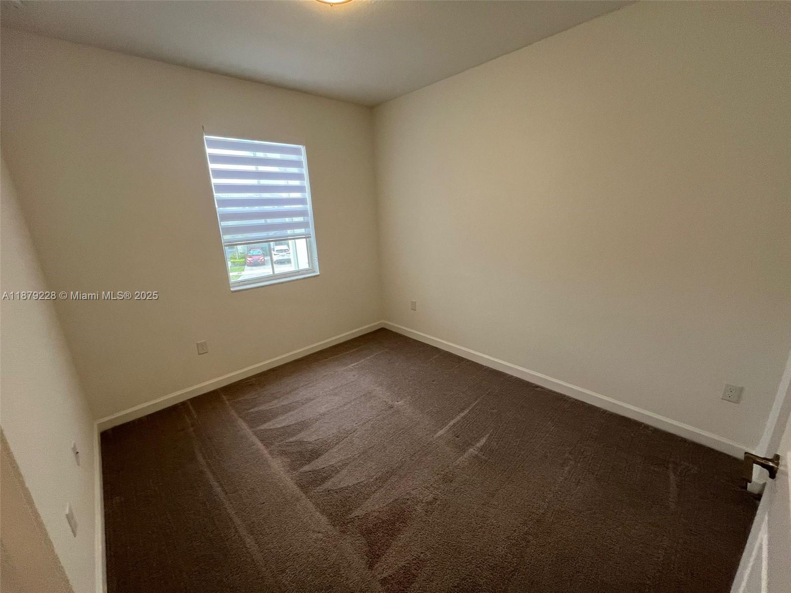 2602 Southeast 11th Street, Unit 2602 Homestead, FL 33035 - Photo 16 of 22 an empty room with a window