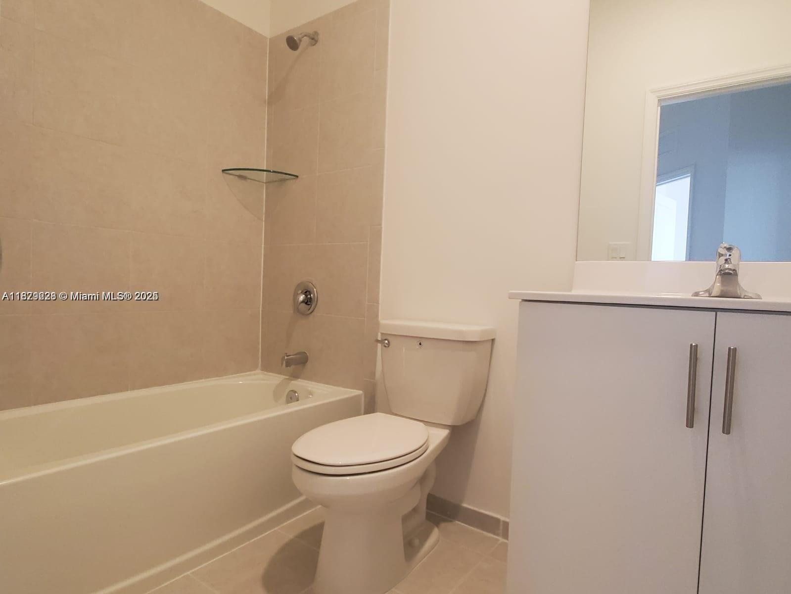 2602 Southeast 11th Street, Unit 2602 Homestead, FL 33035 - Photo 19 of 22 a bathroom with a toilet sink and shower