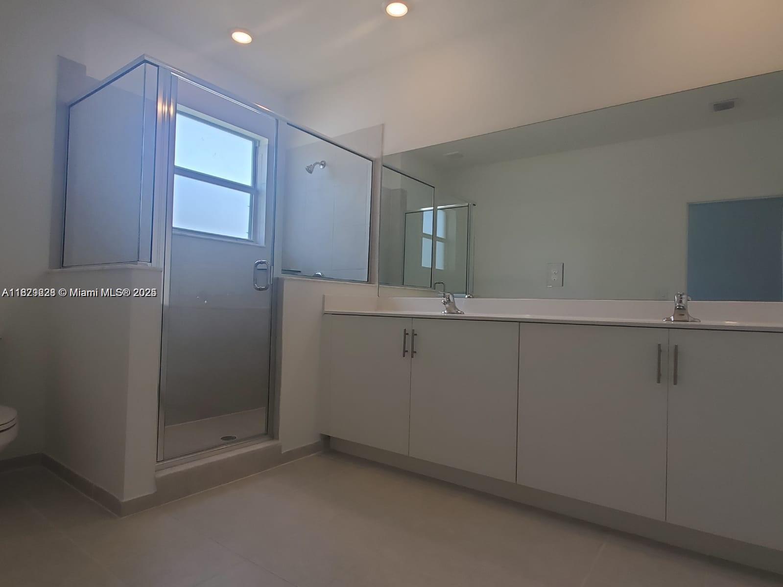 2602 Southeast 11th Street, Unit 2602 Homestead, FL 33035 - Photo 20 of 22 a bathroom with a sink and mirror