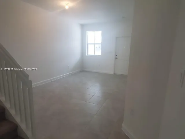 an empty room that has a window in it