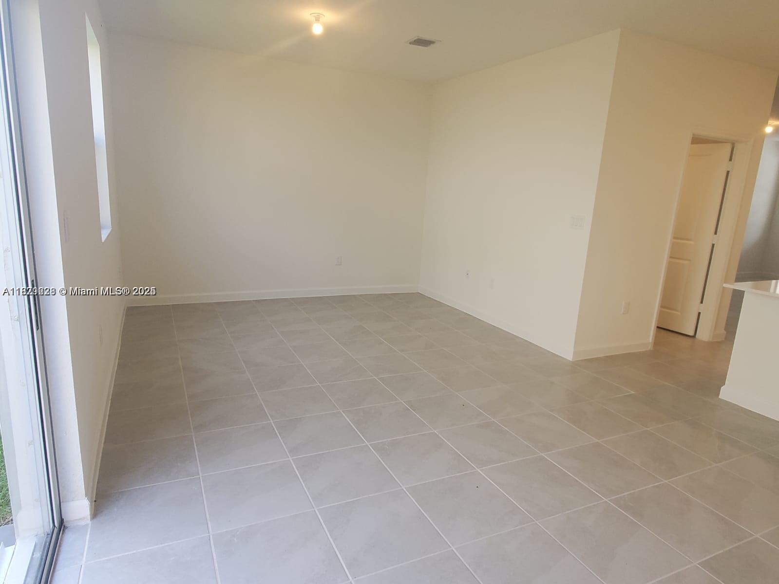 2602 Southeast 11th Street, Unit 2602 Homestead, FL 33035 - Photo 4 of 22 a view of an empty room