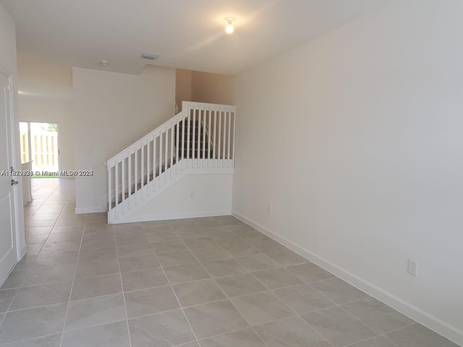 2602 Southeast 11th Street, Unit 2602 Homestead, FL 33035 - Photo 5 of 22 a view of an entryway with wooden floor