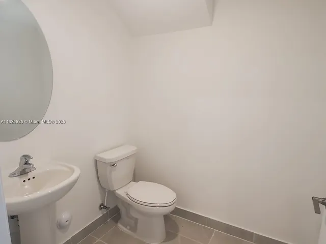 a white toilet sitting next to a white sink