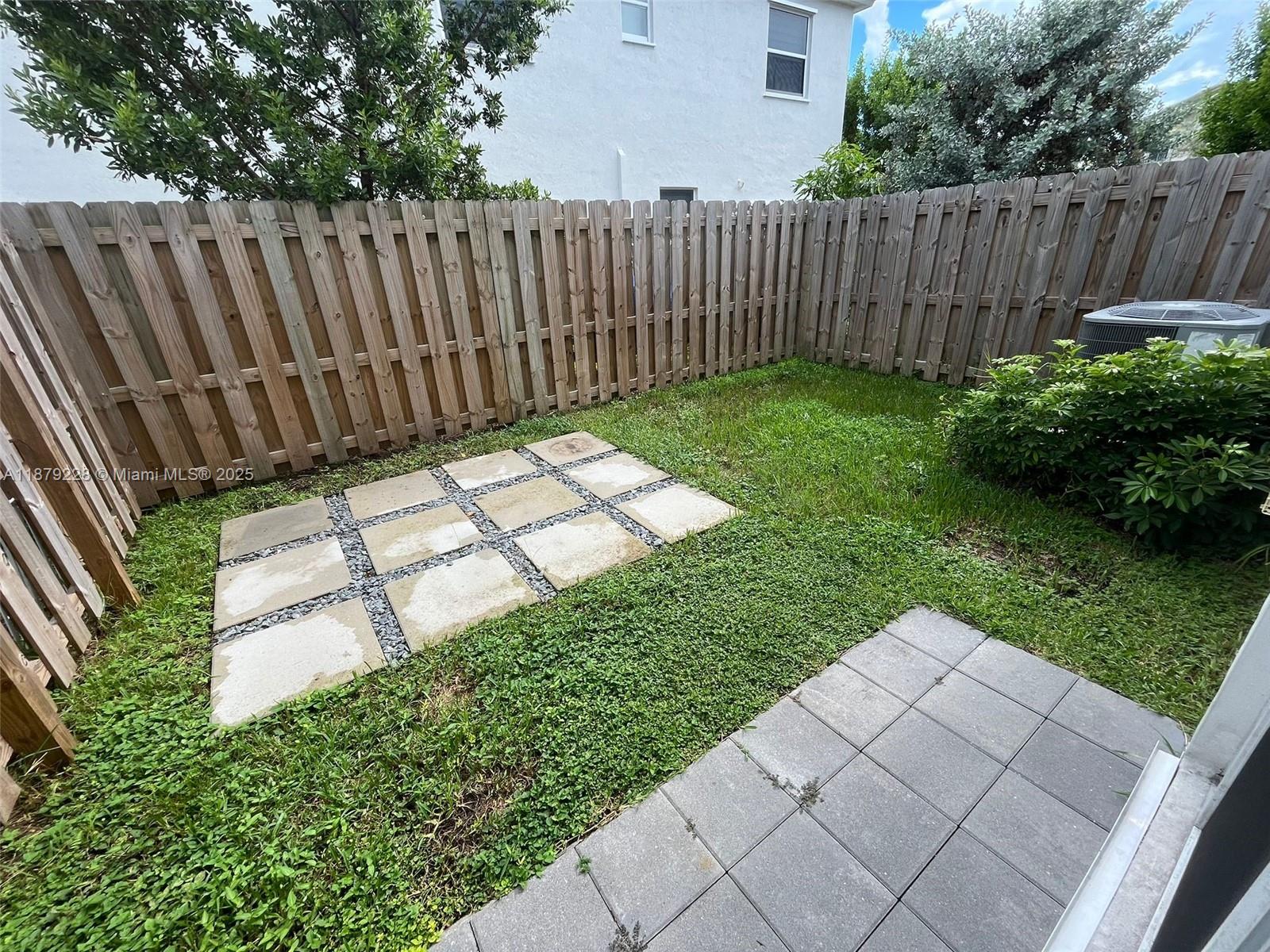 2602 Southeast 11th Street, Unit 2602 Homestead, FL 33035 - Photo 10 of 22 a view of a backyard with wooden fence