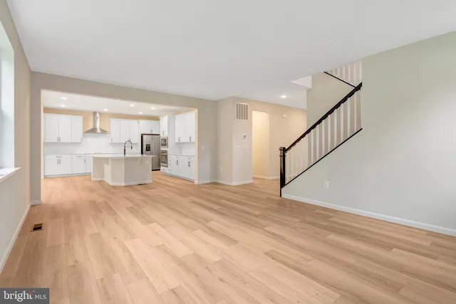 a view of a kitchen with wooden floor and a window