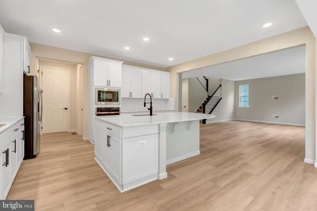 a view of an empty room with windows and chandelier