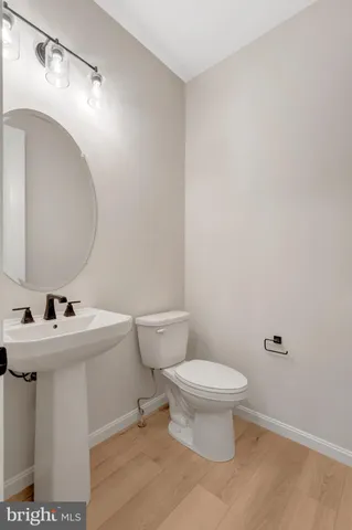 a bathroom with a sink toilet and a mirror