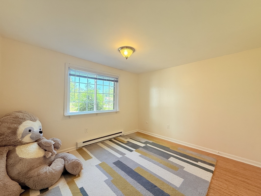 388 Great Road, Unit A1 Acton, MA 01720 - Photo 11 of 18 a bedroom with a bed and a window