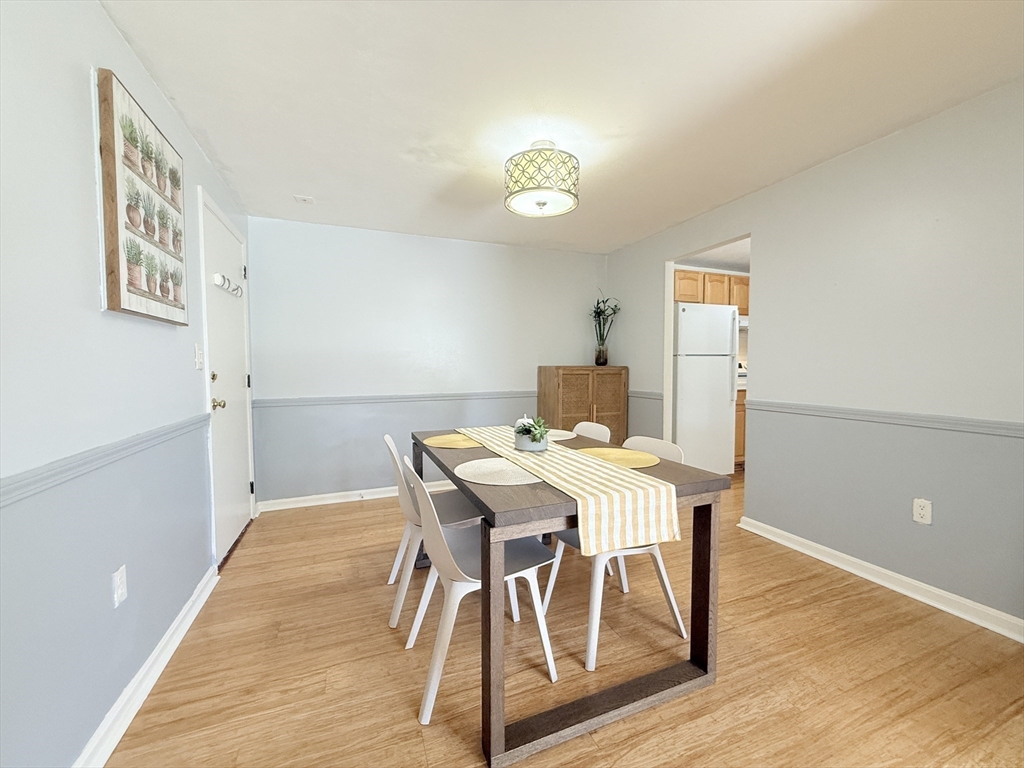 388 Great Road, Unit A1 Acton, MA 01720 - Photo 15 of 18 a view of a dining room with furniture and wooden floor