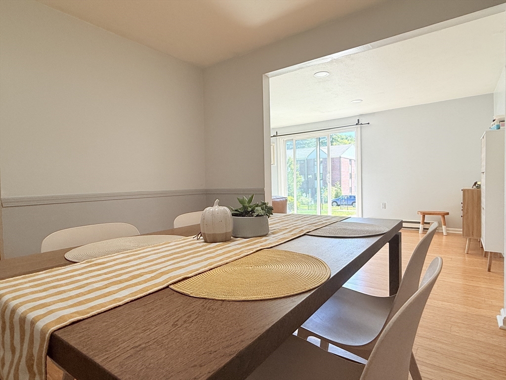 388 Great Road, Unit A1 Acton, MA 01720 - Photo 16 of 18 a bedroom with a bed and wooden floor