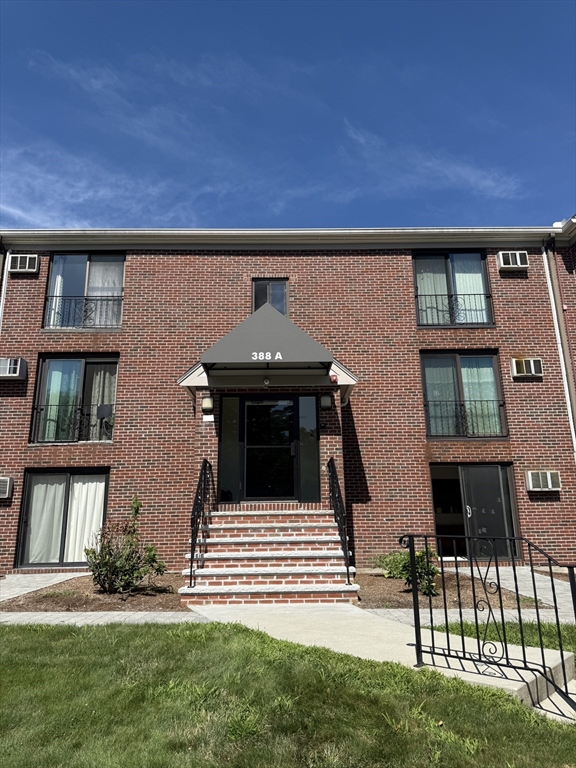 388 Great Road, Unit A1 Acton, MA 01720 - Photo 2 of 18 front view of a house with a yard