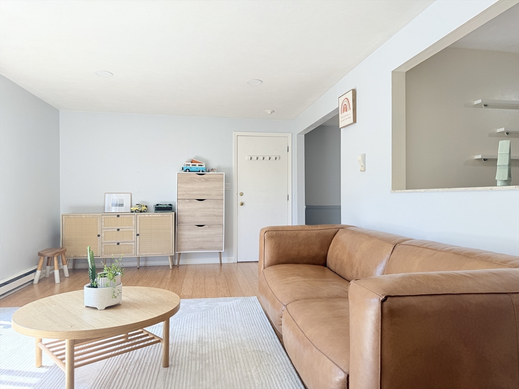 388 Great Road, Unit A1 Acton, MA 01720 - Photo 3 of 18 a living room with furniture and wooden floor