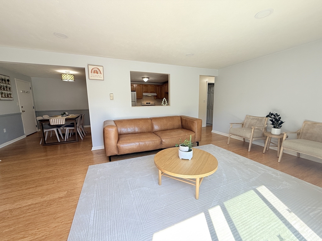 388 Great Road, Unit A1 Acton, MA 01720 - Photo 4 of 18 a living room with furniture and a wooden floor