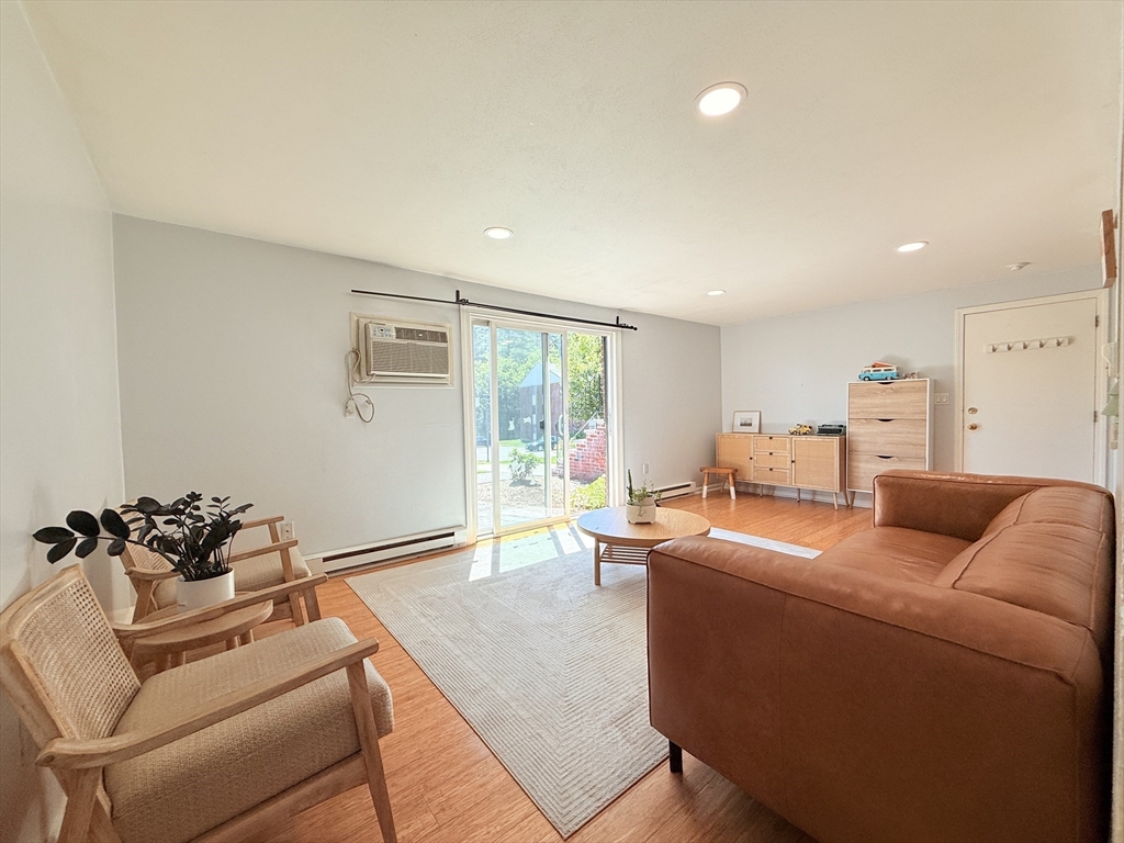 388 Great Road, Unit A1 Acton, MA 01720 - Photo 5 of 18 a living room with furniture and a large window