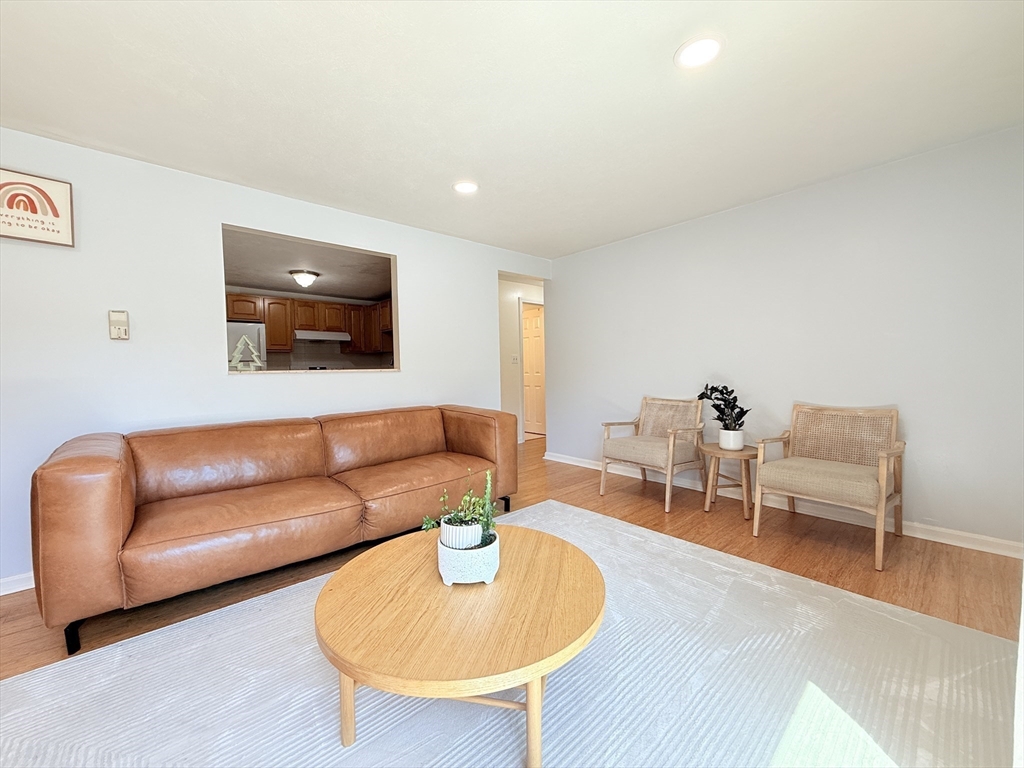 388 Great Road, Unit A1 Acton, MA 01720 - Photo 6 of 18 a living room with furniture and a wooden floor